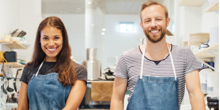 Photo of two people smiling in a restaurant kitchen
