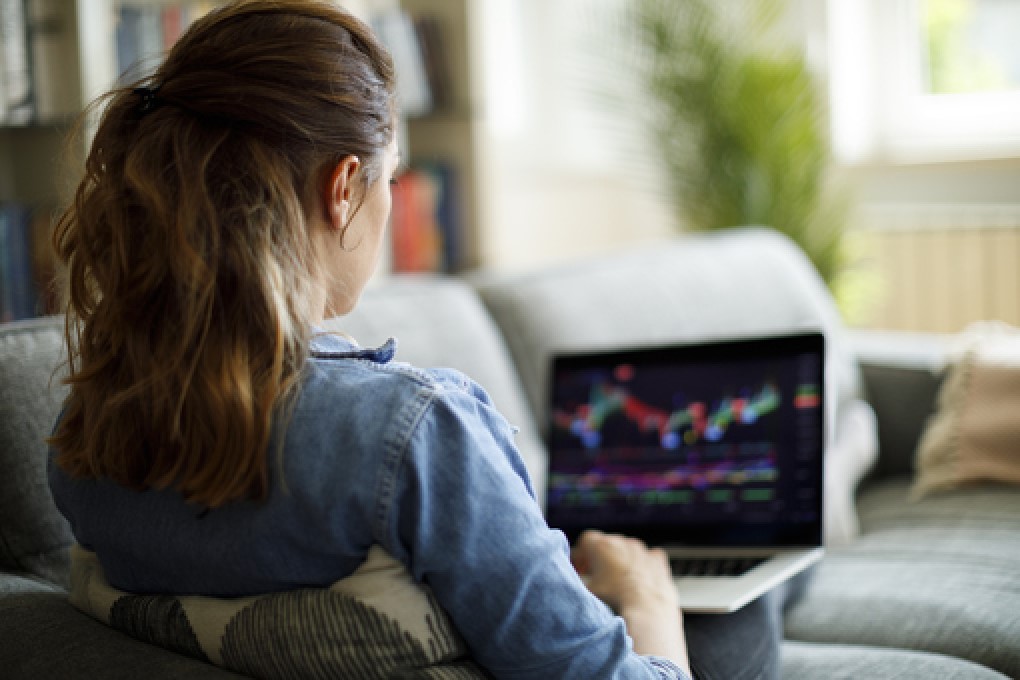 Young woman viewing stock charts on her computer