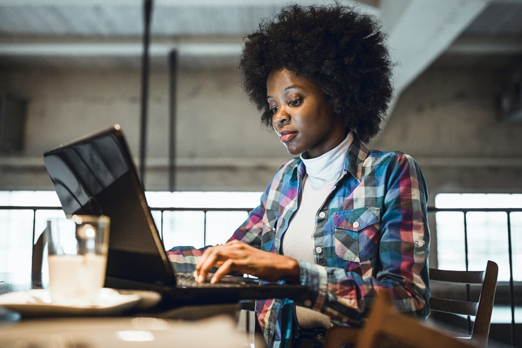 A woman in front of a computer screen.